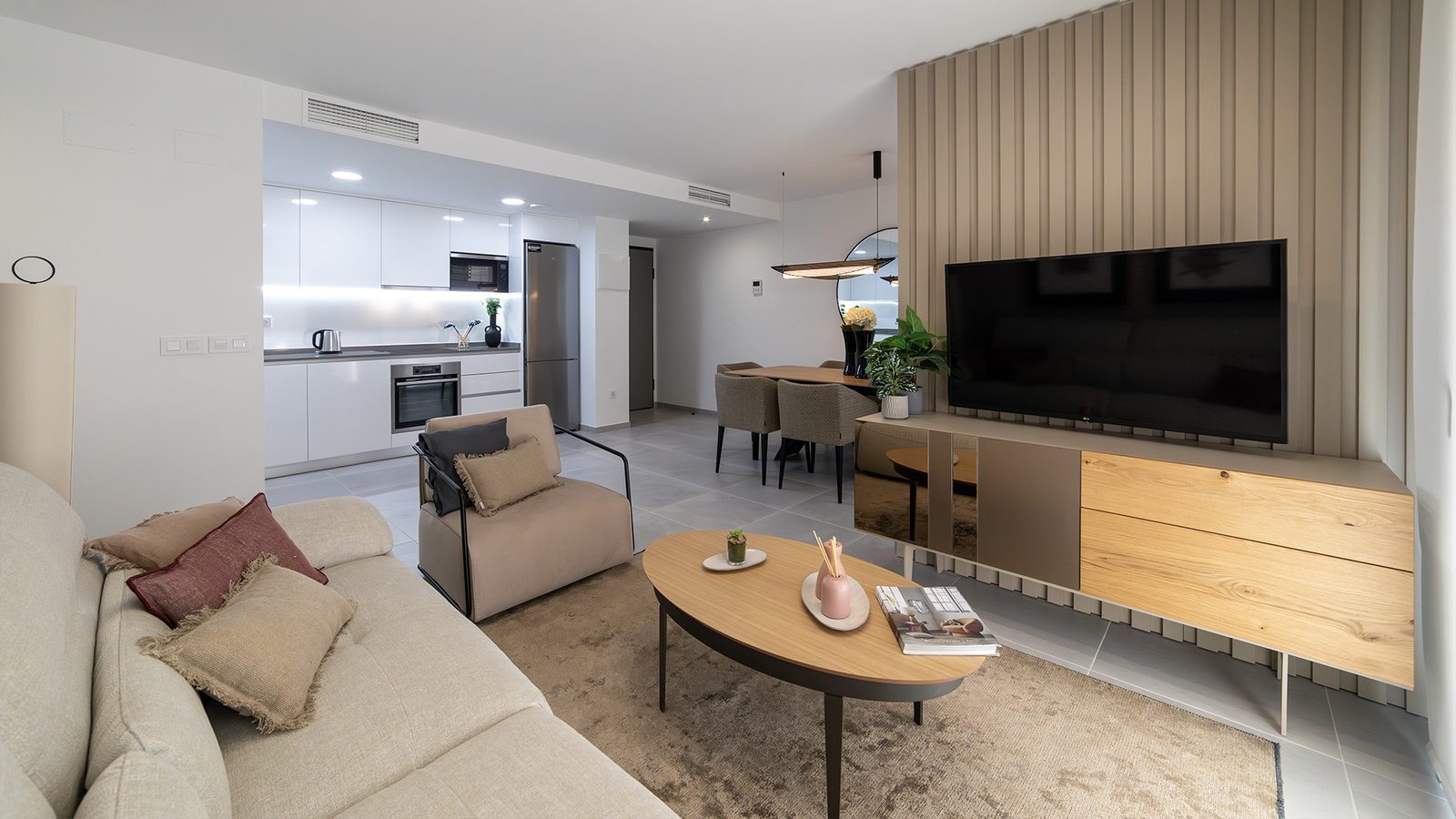 Open-plan living room, dining area and modern kitchen of a 3-bedroom apartment in Torrevieja - The Estates