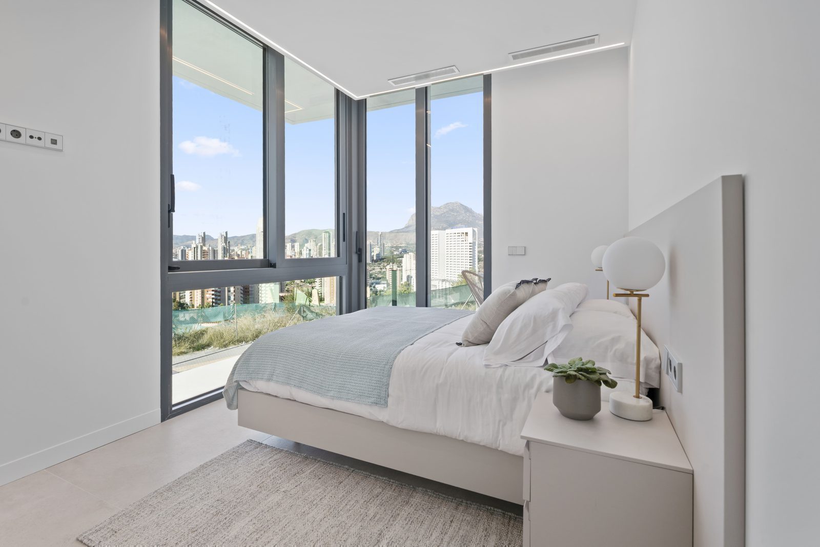 A bright bedroom with stunning sea and city views in a 4-bedroom villa in Benidorm - The Estates