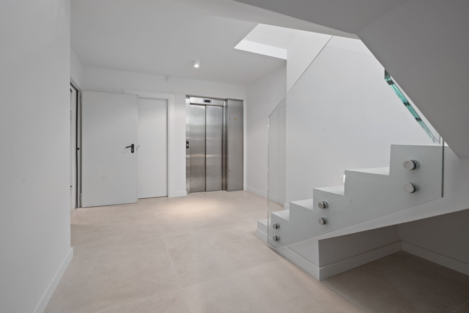 Modern interior hallway with elevator and staircase in a 4-bedroom villa in Benidorm - The Estates