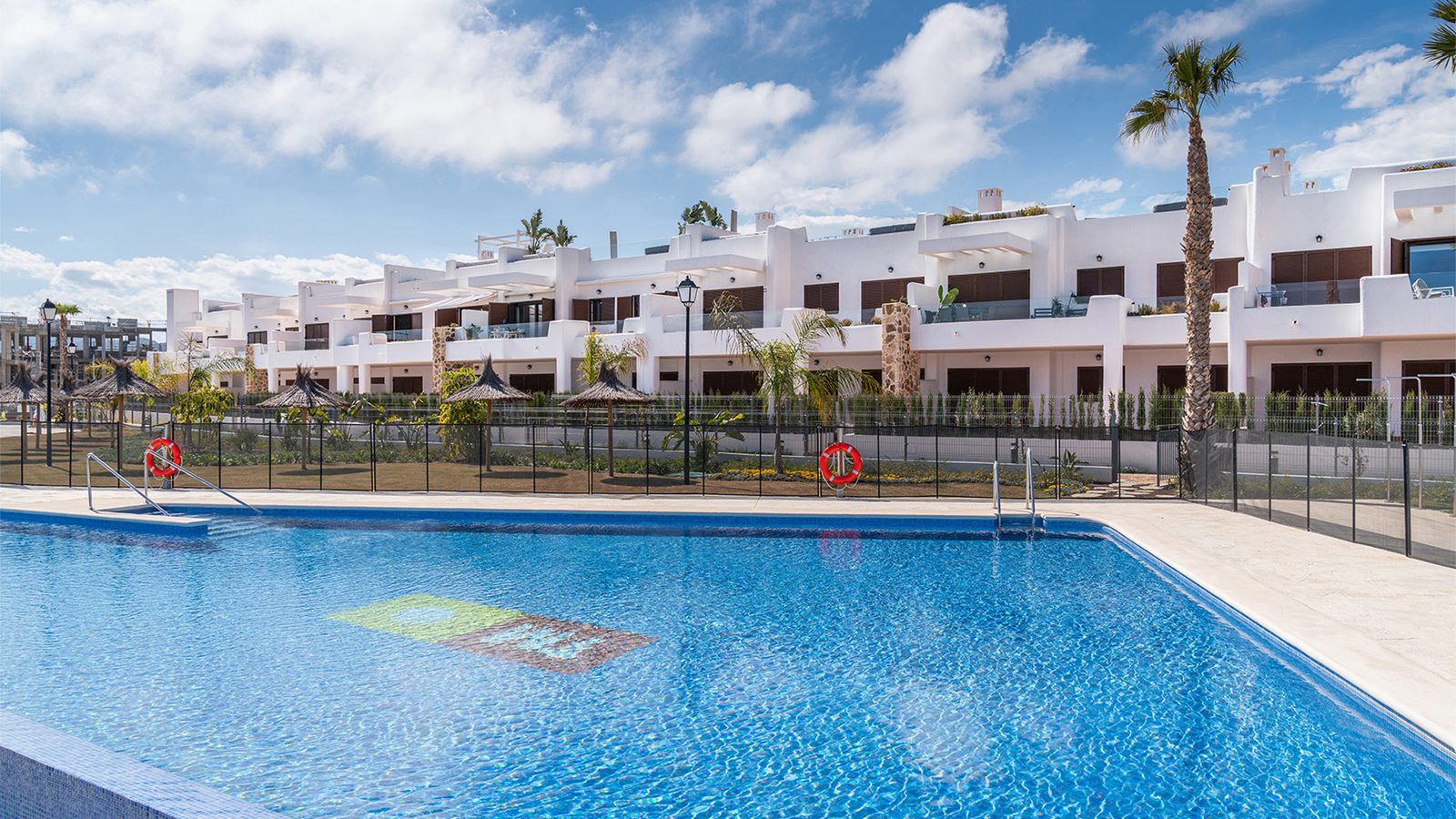 A view of the swimming pool and a row of a 2-bedroom bungalow in Pulpí - The Estates