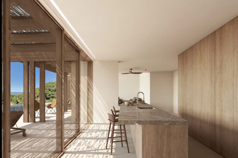 Modern kitchen with bar area and sea views inside a 3-bedroom villa in Benissa - The Estates
