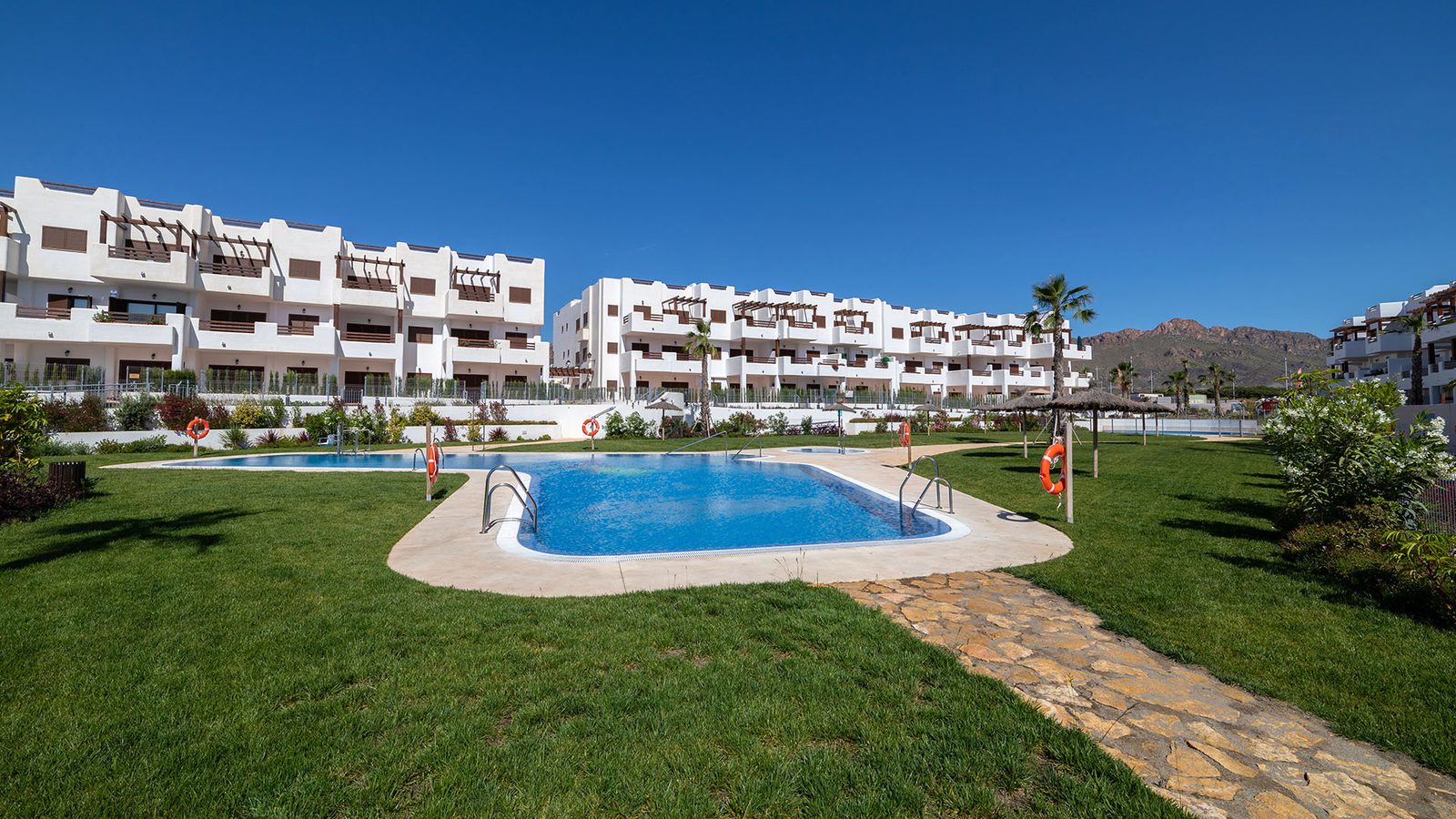 A swimming pool and landscaped garden area of a 3-bedroom bungalow in Pulpí - The Estates