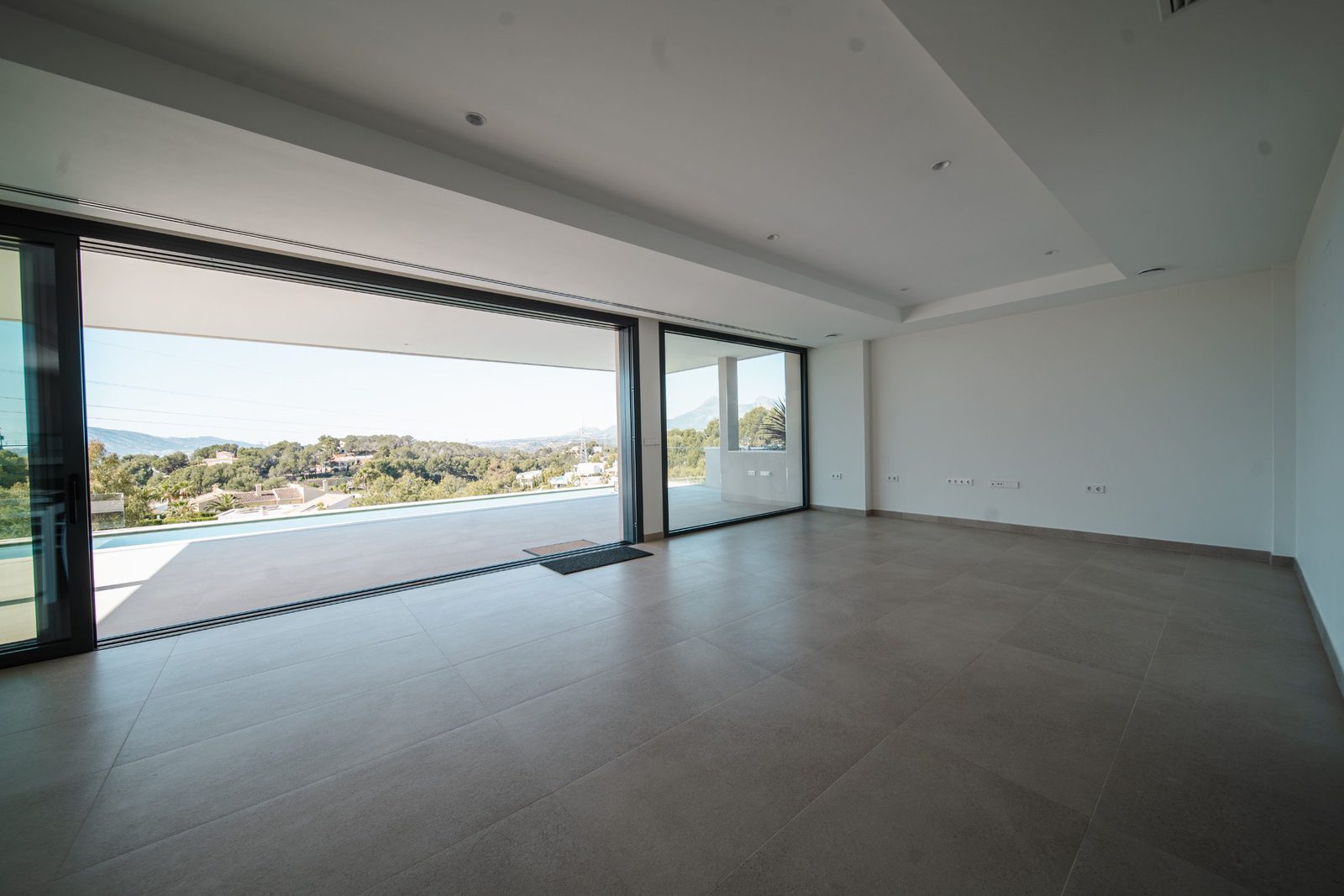 Bright living room with expansive sea and golf views in a 5-bedroom villa in Altea - The Estates