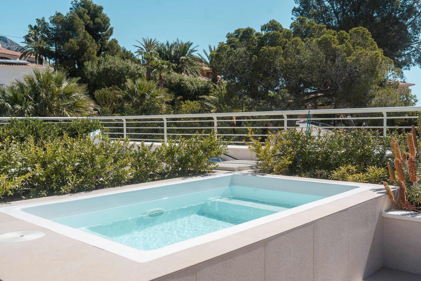 A private plunge pool and lush greenery surround a 5-bedroom villa in Altea - The Estates