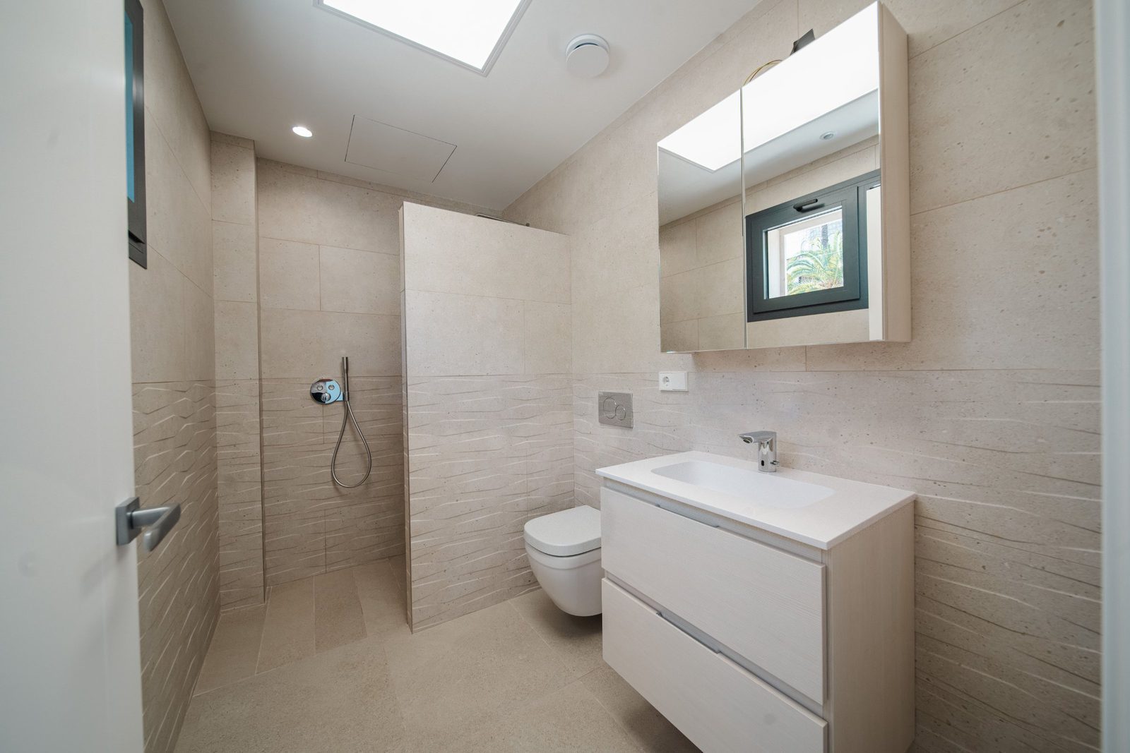 A modern bathroom with a walk-in shower and vanity in a 5-bedroom villa in Altea - The Estates