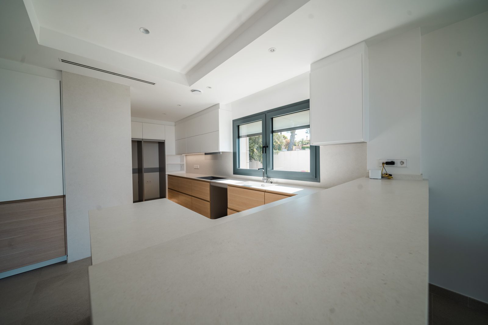 Modern kitchen with window in a 5-bedroom villa in Altea - The Estates