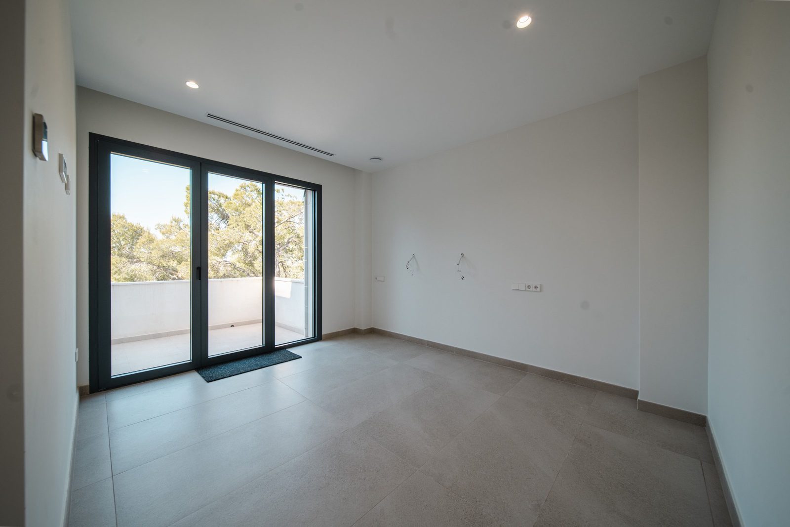 Bright, modern living room with patio doors of a 5-bedroom villa in Altea - The Estates