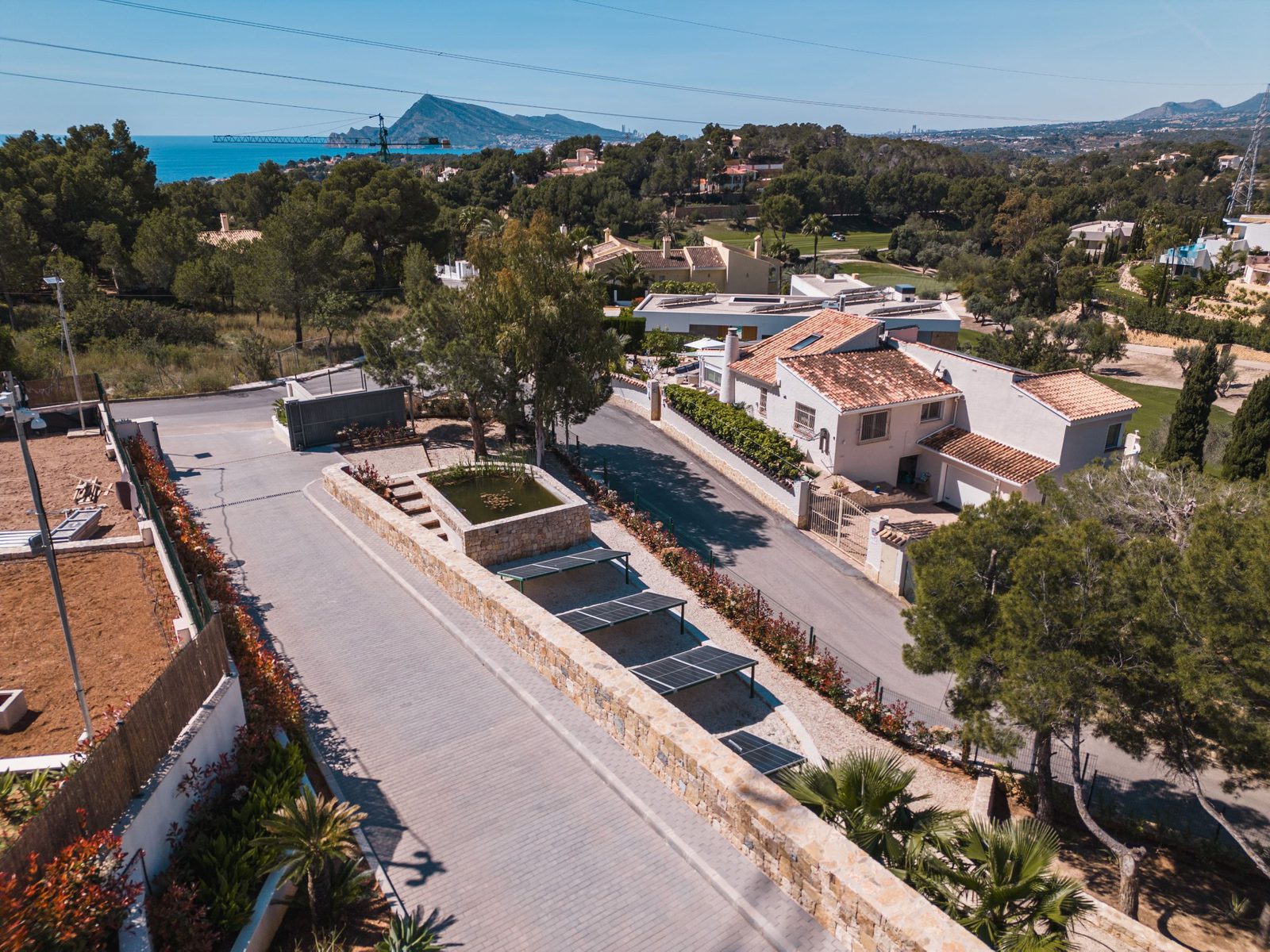 An aerial view of a luxurious 5-bedroom villa with sea and golf views in Altea - The Estates