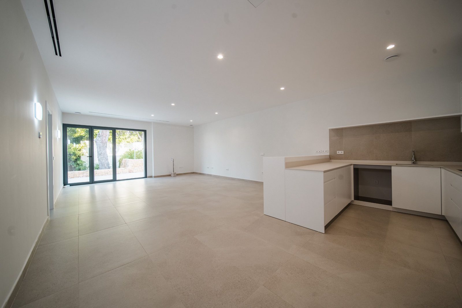 Modern kitchen and living area with garden views in a 5-bedroom villa in Altea - The Estates