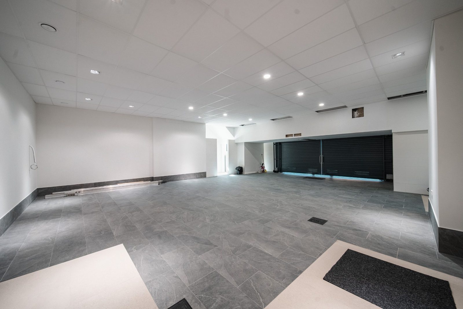 An empty, spacious garage with tiled floors in a 5-bedroom villa in Altea - The Estates