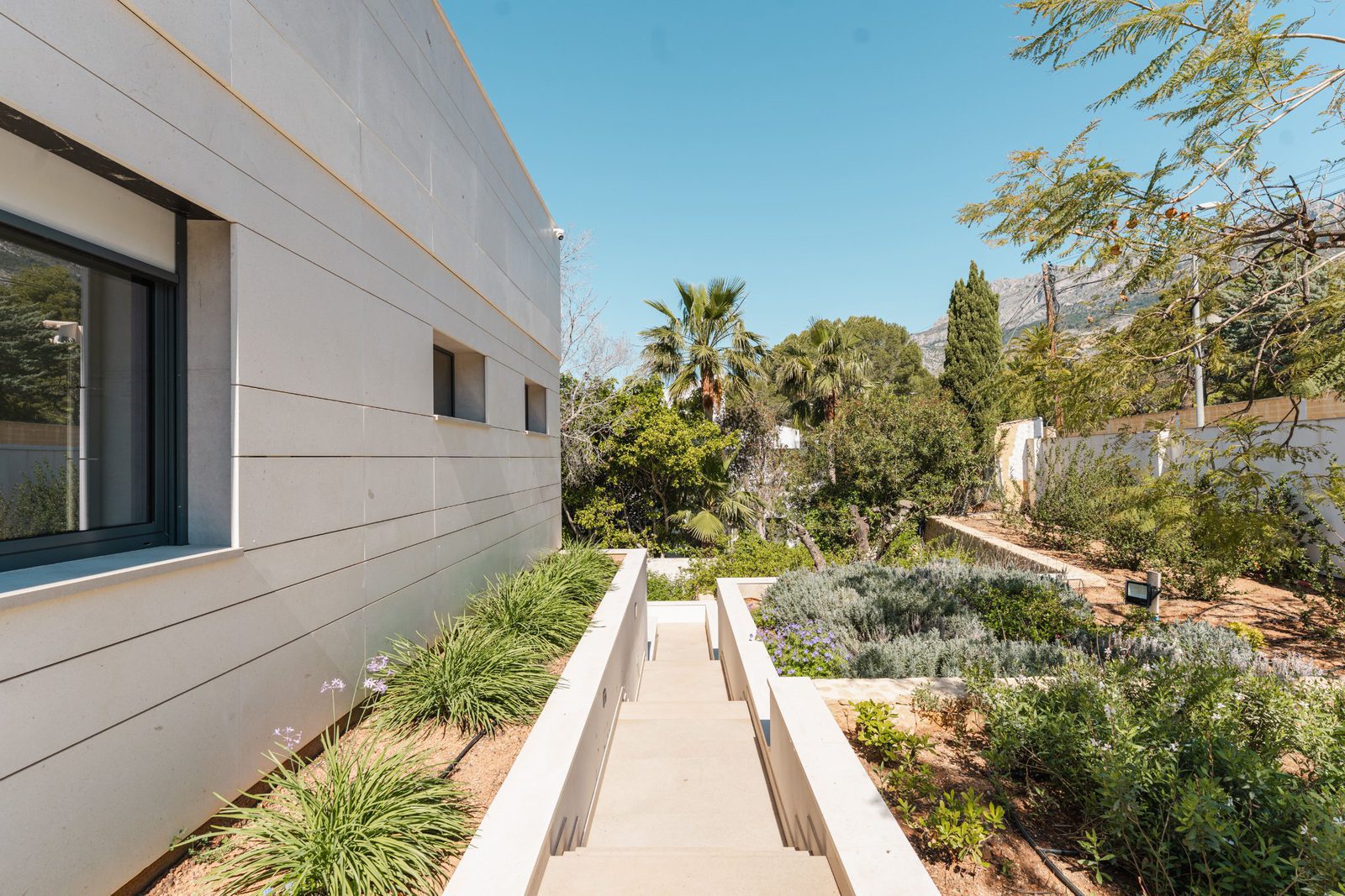 Modern exterior architecture and lush landscaping of a 5-bedroom villa in Altea - The Estates