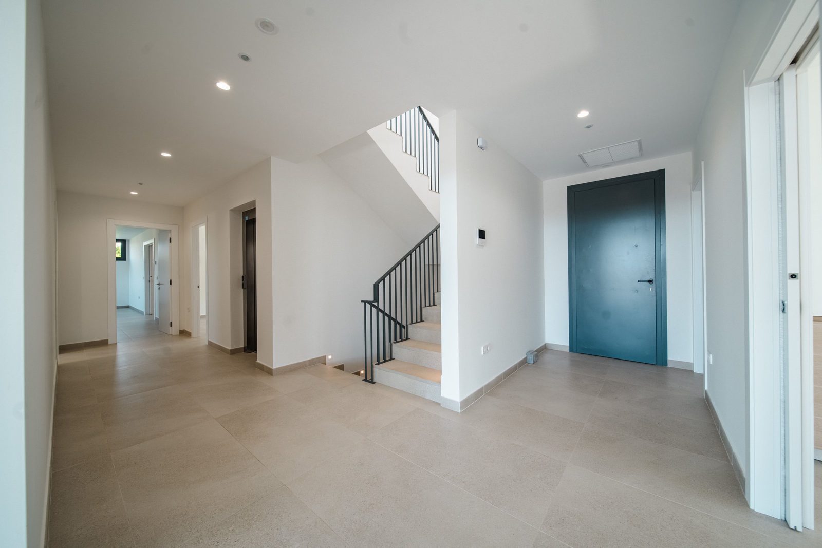 Modern interior hallway with staircase and door in a 5-bedroom villa in Altea - The Estates