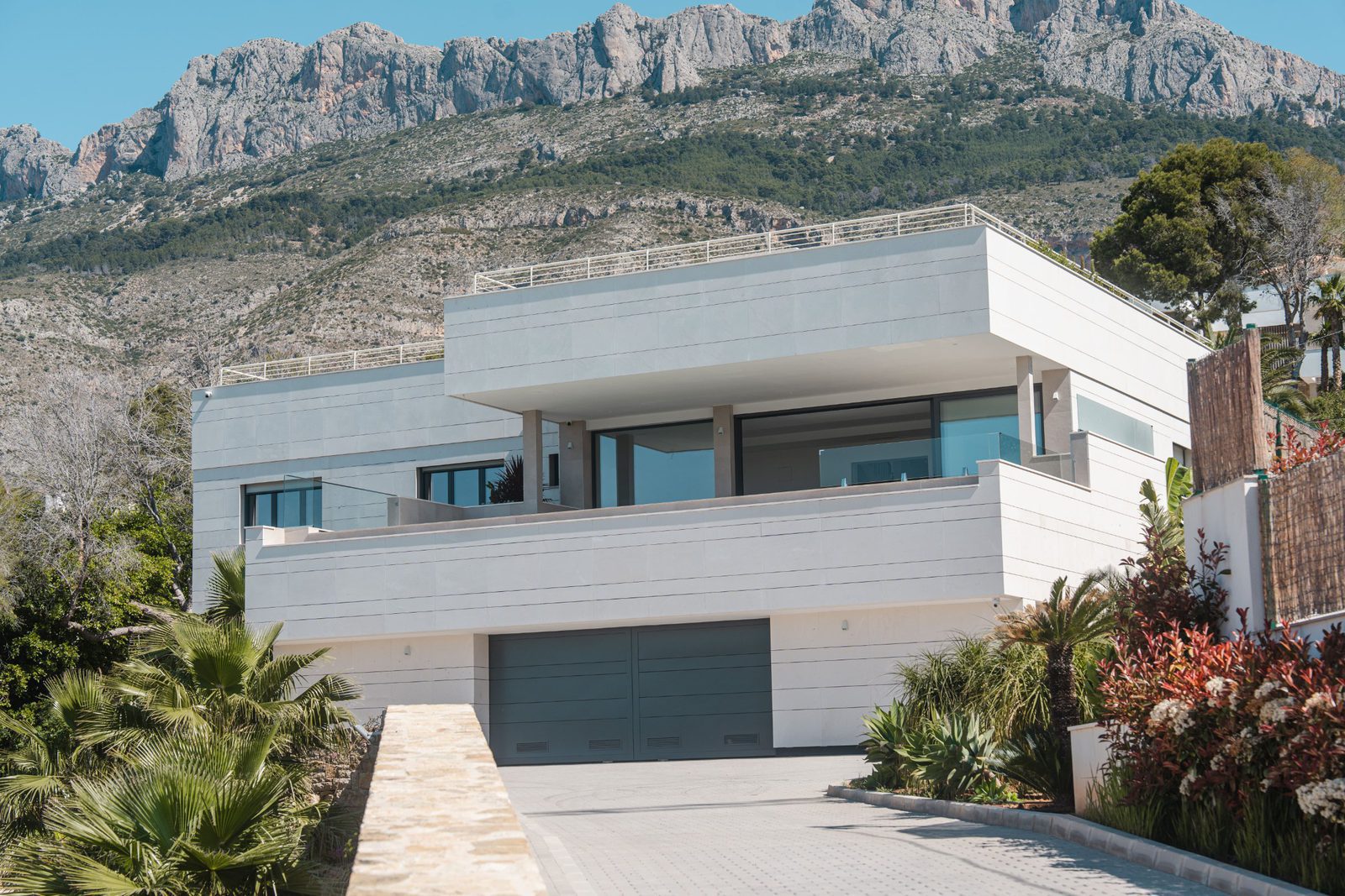 A modern villa with mountain views, showcasing the exterior of a 5-bedroom villa in Altea - The Estates