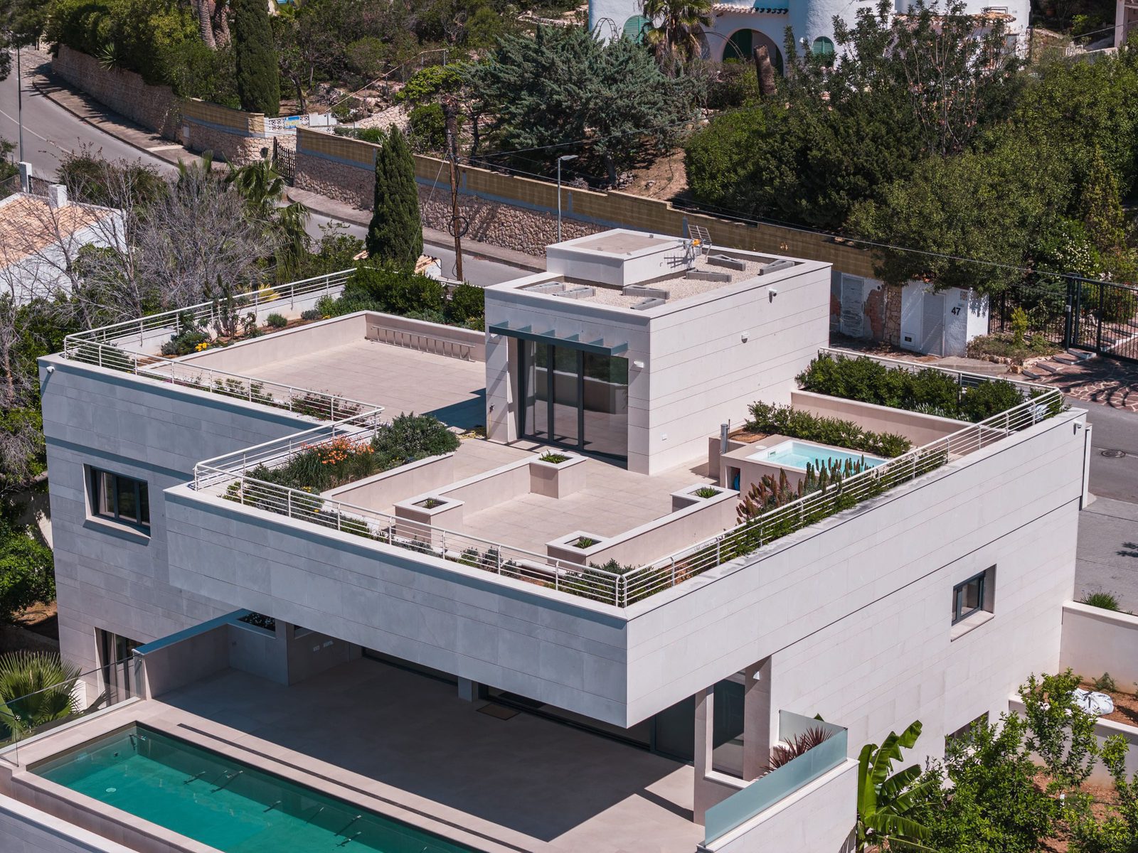 An aerial view of a modern 5-bedroom villa with a rooftop terrace and pool in Altea - The Estates