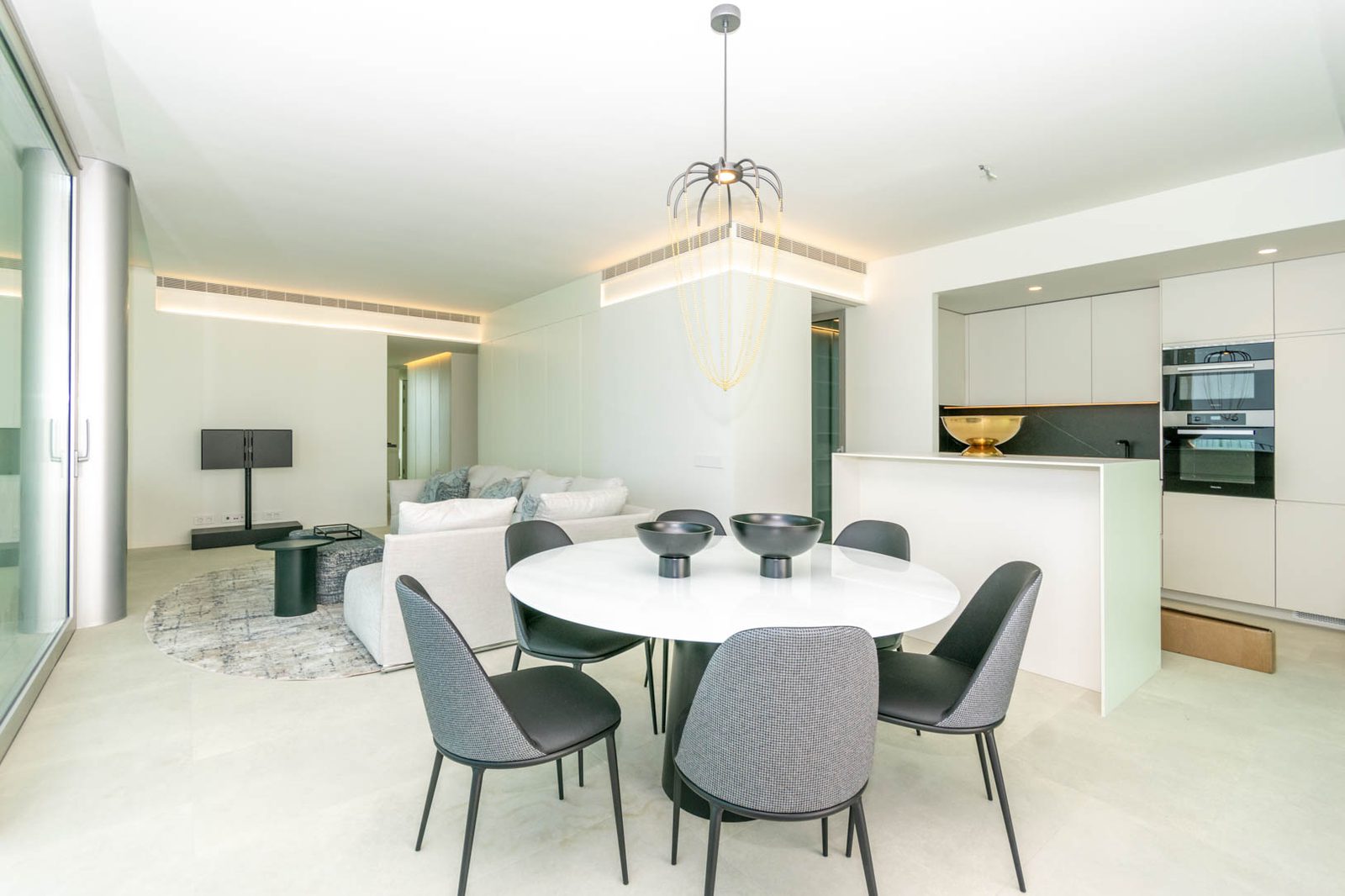 Modern living and dining area of a 4-bedroom apartment in Calpe - The Estates