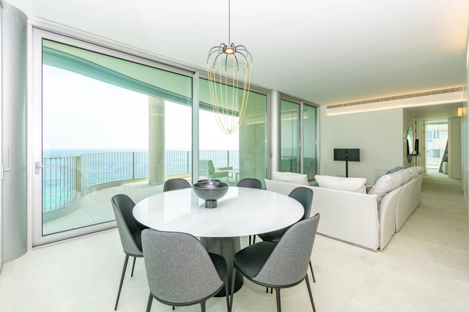 Stylish living and dining area with stunning sea views in a 4-bedroom apartment in Calpe - The Estates
