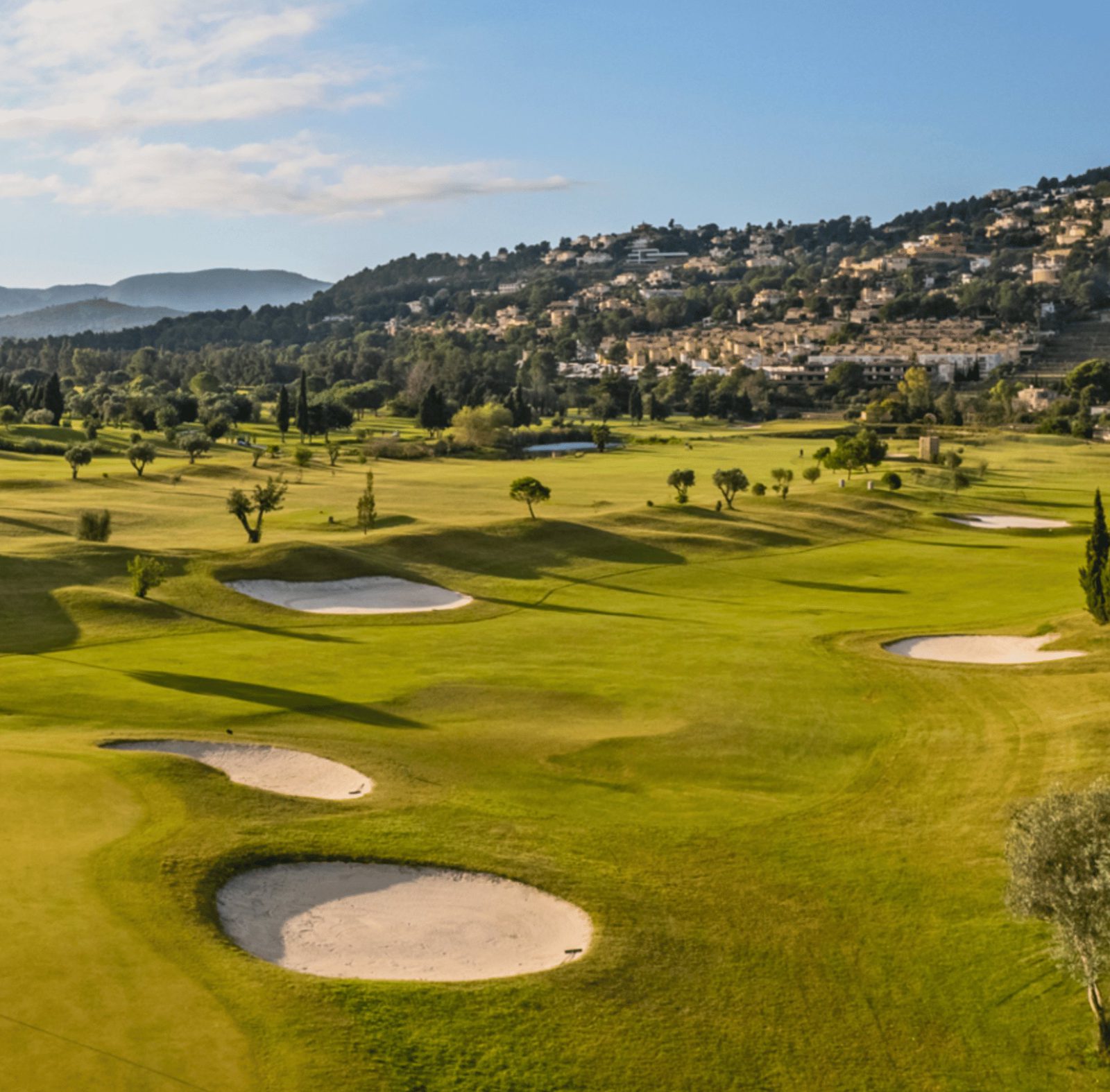 A scenic view of the golf course and surrounding countryside from a 3-bedroom apartment in Pedreguer - The Estates