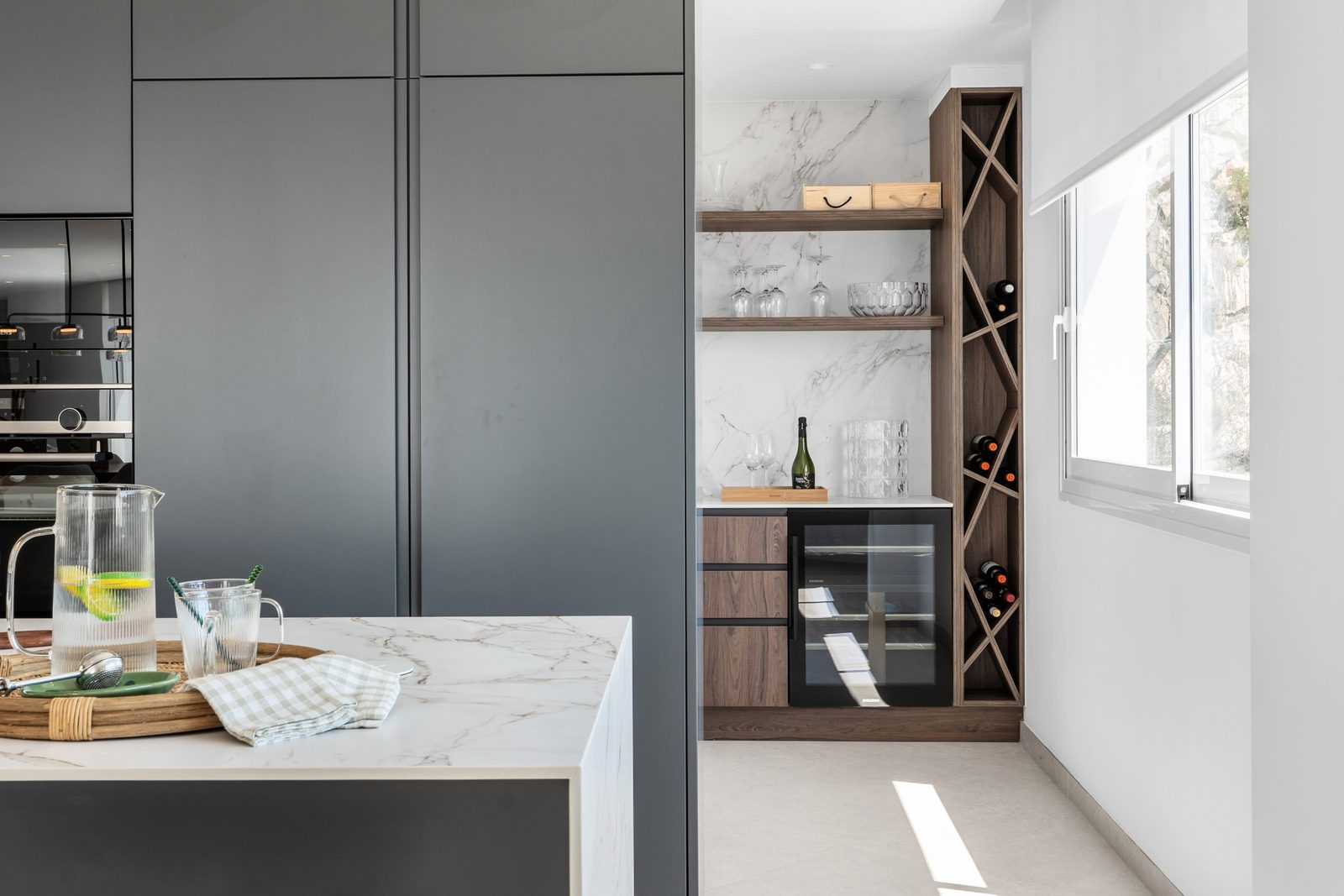 Stylish kitchen with marble details and a wine storage area in a 4-bedroom villa in Altea - The Estates