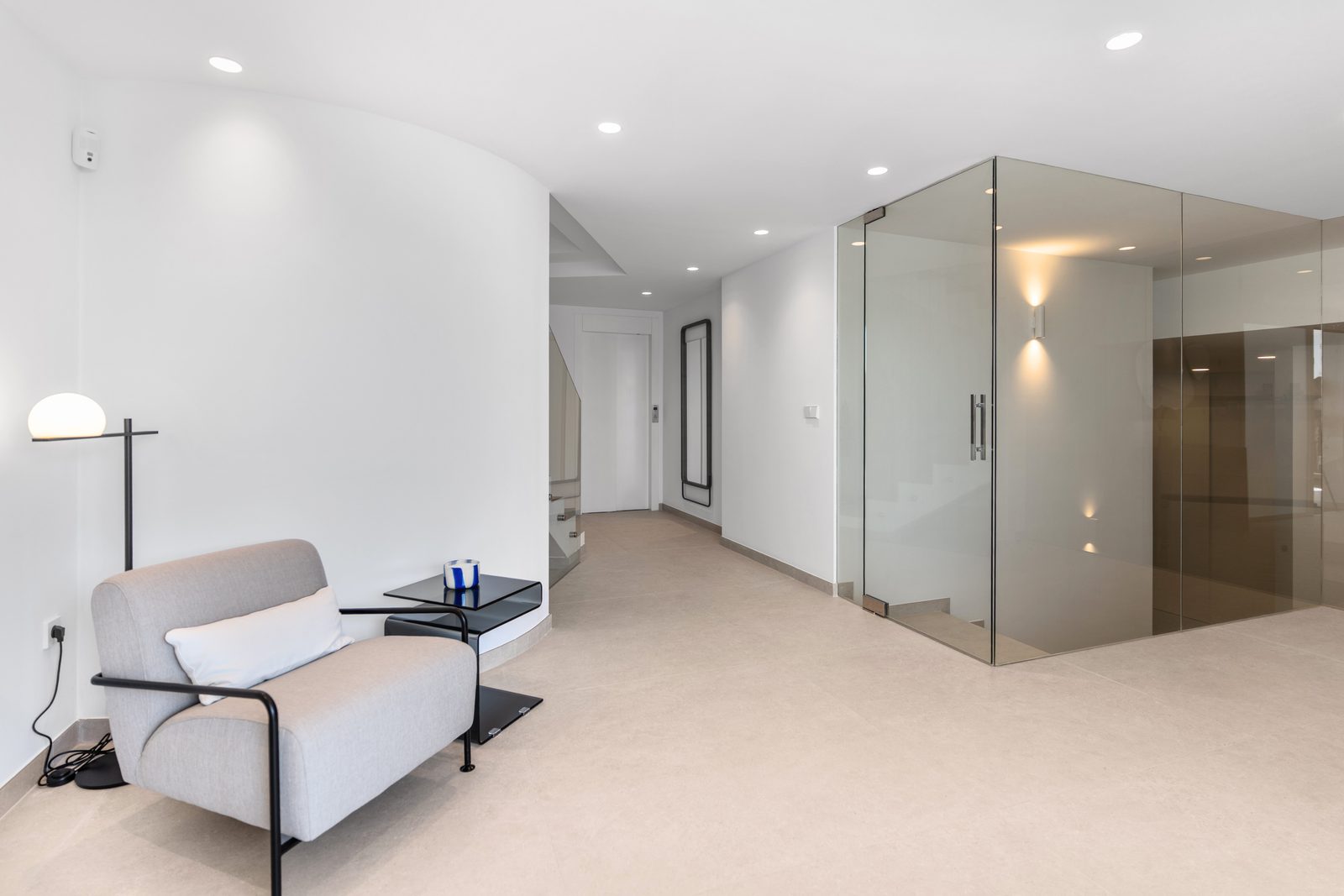 Modern interior hallway with seating and glass doors in a 4-bedroom villa in Altea - The Estates