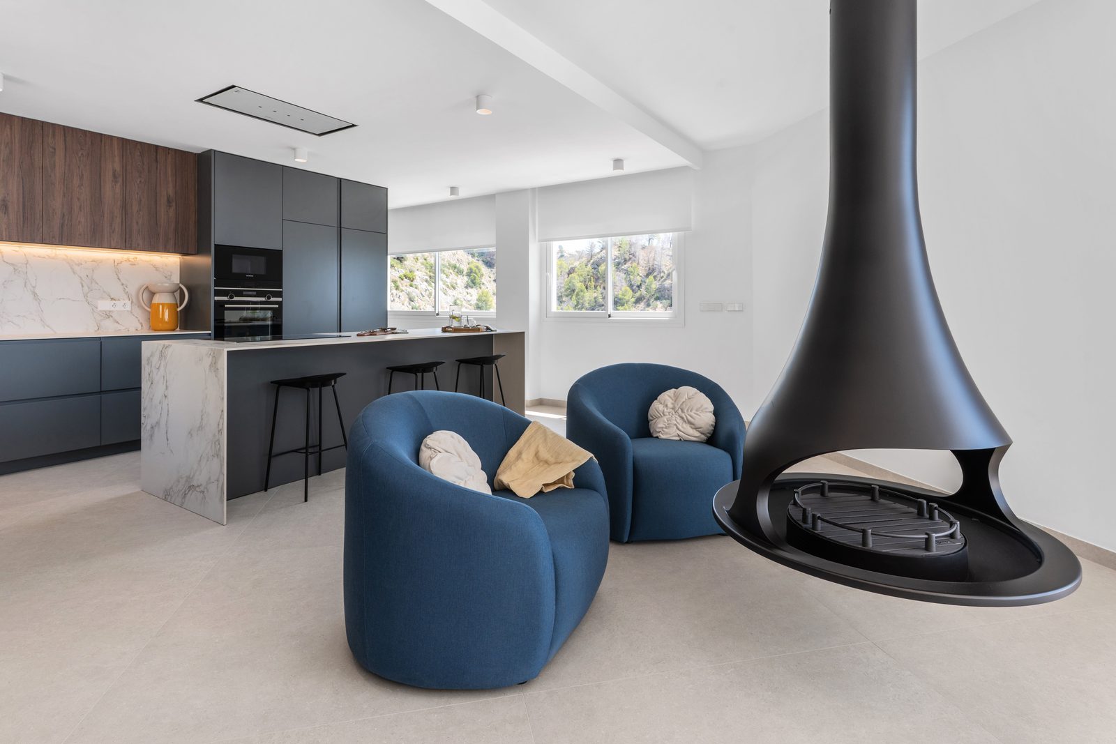 Modern kitchen and lounge area with a striking fireplace in a 4-bedroom villa in Altea - The Estates