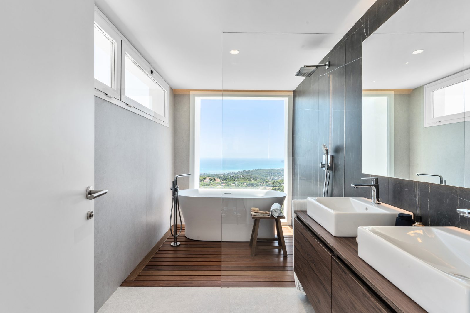 A modern bathroom with a freestanding tub and stunning sea views in a 4-bedroom villa in Altea - The Estates