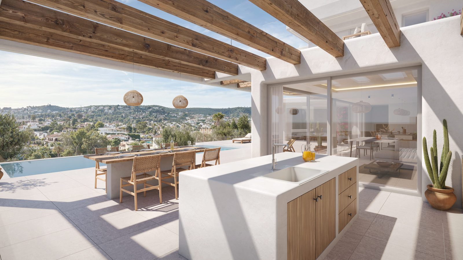 Outdoor kitchen and dining terrace with infinity pool and sea views of a 4-bedroom villa in