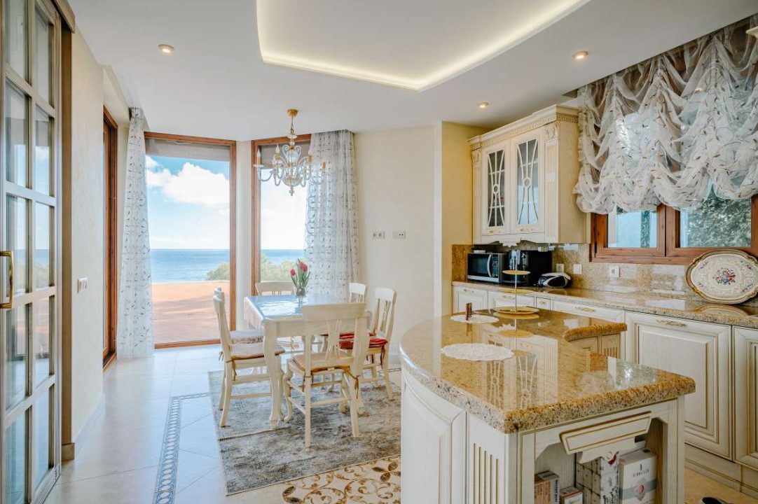 Elegant kitchen and dining area with sea views inside a 6-bedroom villa in Calpe - The Estates