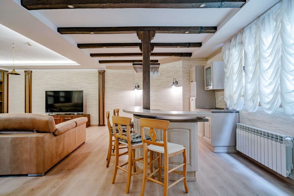 Stylish living and dining area with exposed beams in a 6-bedroom villa in Calpe - The Estates