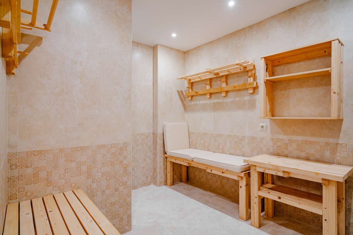 A luxurious sauna with wooden benches and tiled walls in a 6-bedroom villa in Calpe - The Estates