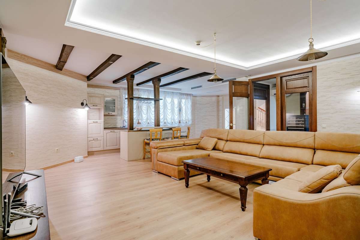 Stylish living room with wooden beams and a comfortable sofa in a 6-bedroom villa in Calpe - The Estates