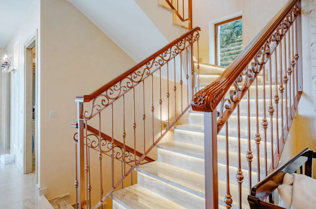 Elegant staircase with wooden banister and marble steps inside a 6-bedroom villa in Calpe - The Estates