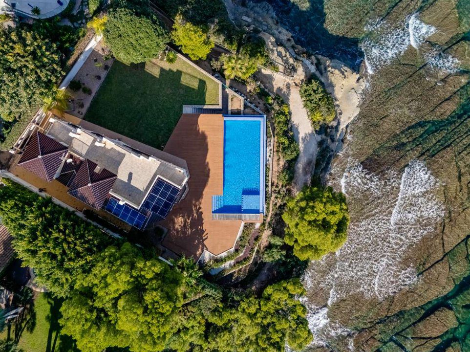 Aerial view of a luxurious 6-bedroom villa with a pool and stunning sea views in Calpe - The Estates