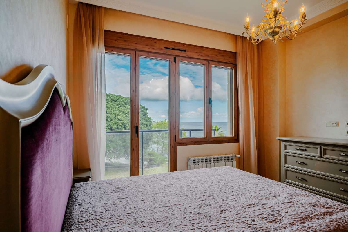 A bright bedroom with sea views from a large window in a 6-bedroom villa in Calpe - The Estates