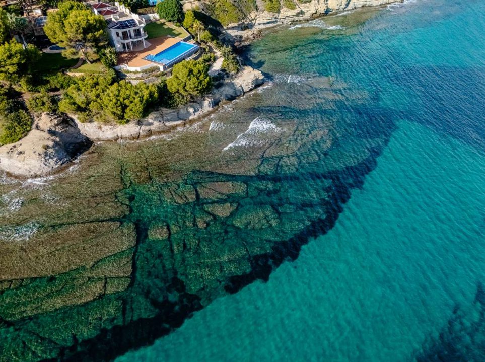 Aerial view of a stunning 6-bedroom villa and its private pool overlooking the sea in Calpe - The Estates