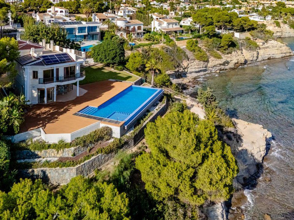 An aerial view of a luxurious villa with a pool and stunning sea views in Calpe - The Estates