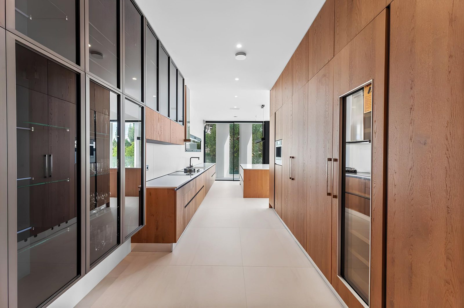 Modern kitchen with wooden cabinetry and sleek appliances in a 7-bedroom villa in Altea - The Estates