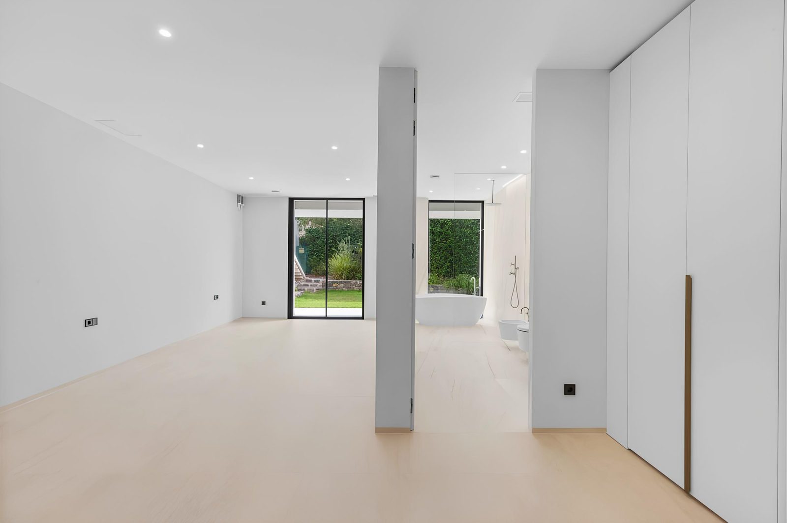 Modern bathroom with a freestanding tub and garden views in a 7-bedroom villa in Altea - The Estates