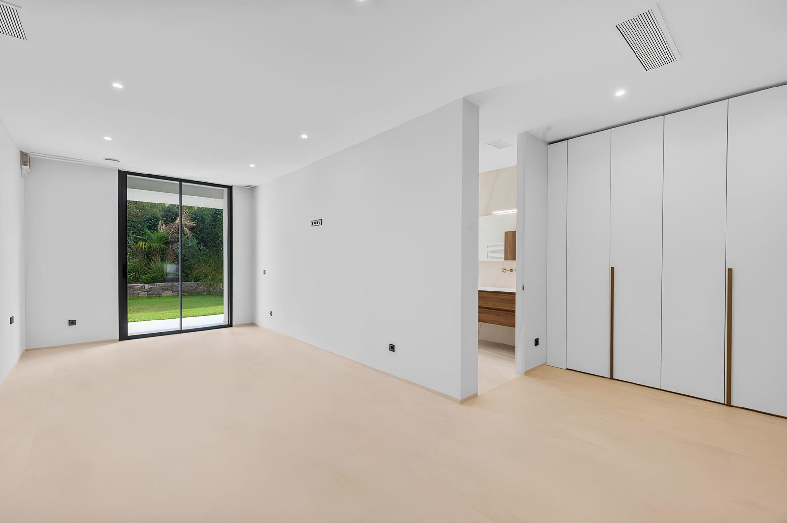 A bright, modern bedroom with large windows and built-in wardrobes in a 7-bedroom villa in Altea - The Estates