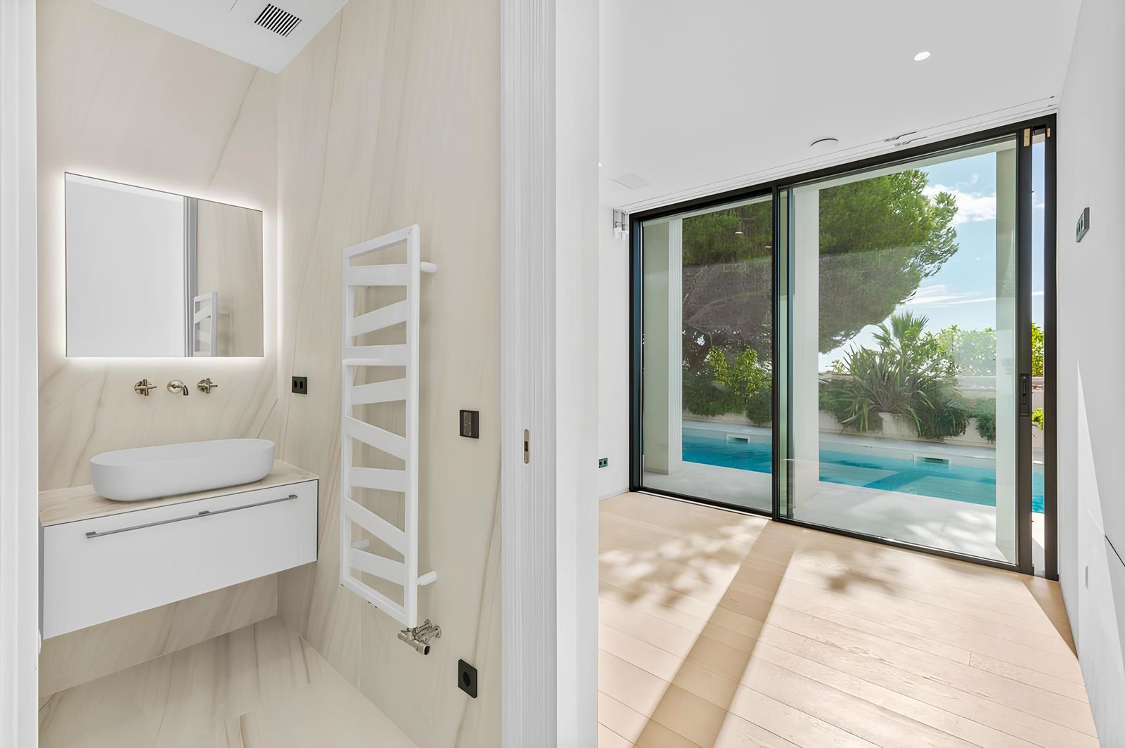 A modern bathroom with a view of the pool in a 7-bedroom villa in Altea - The Estates