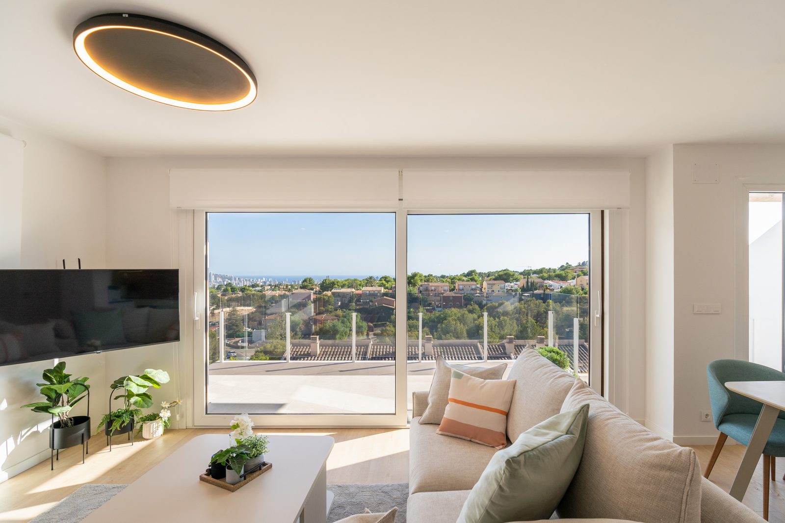 A bright living room with sea and city views from a 4-bedroom townhouse in La Nucía - The Estates