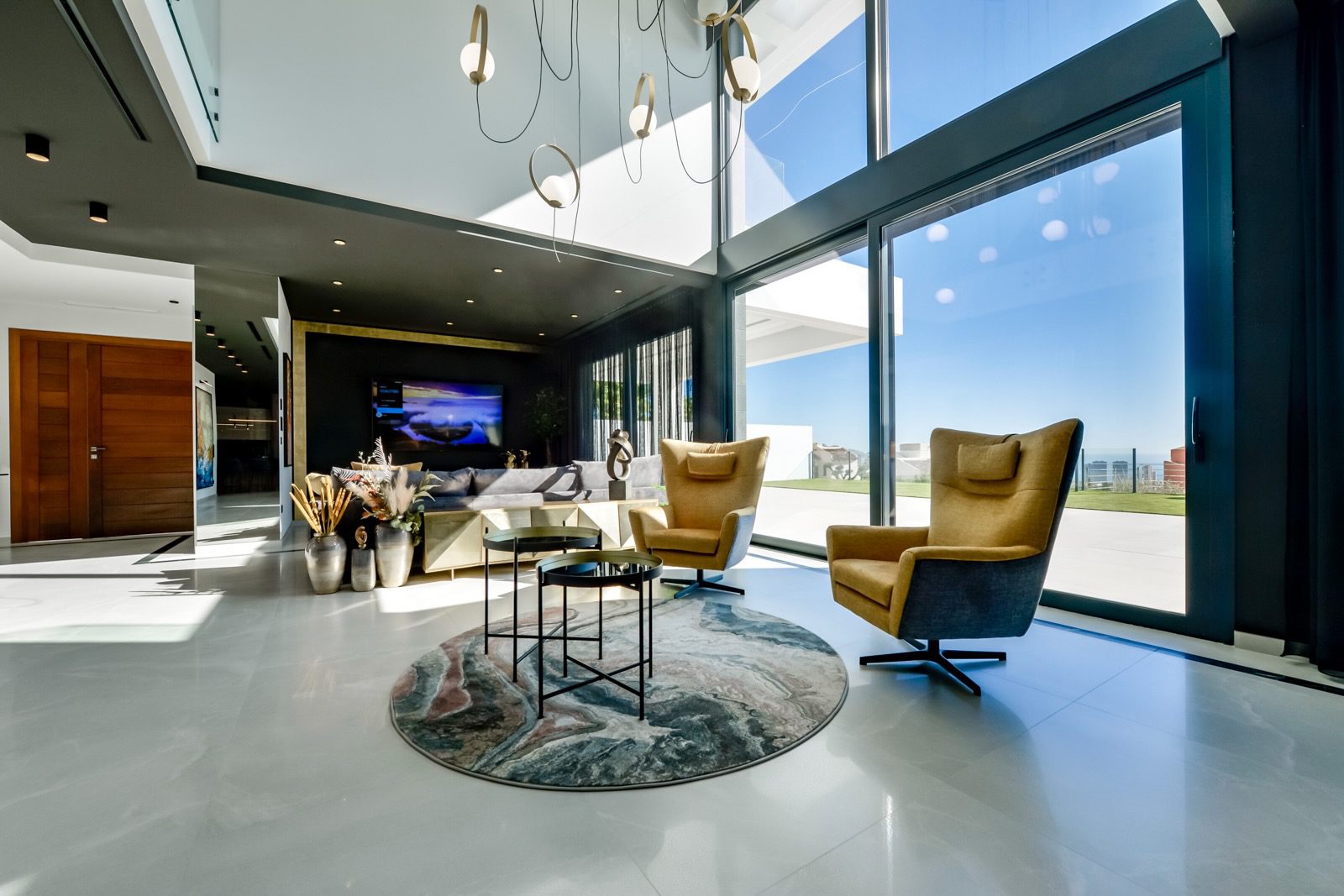 Stylish living room with large windows and modern furnishings in a 7-bedroom villa in Finestrat - The Estates