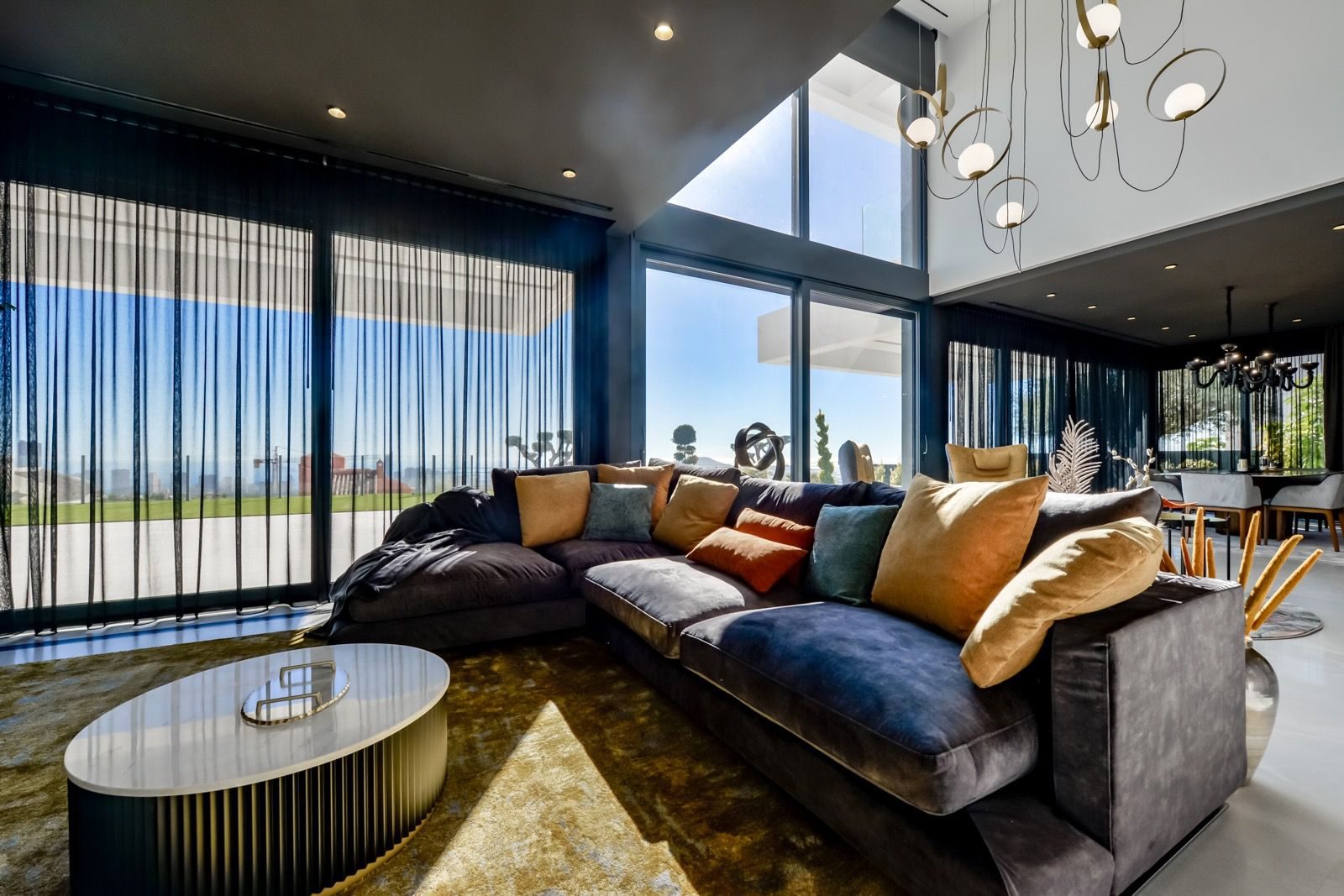 Stylish living room with large windows and sea views in a 7-bedroom villa in Finestrat - The Estates