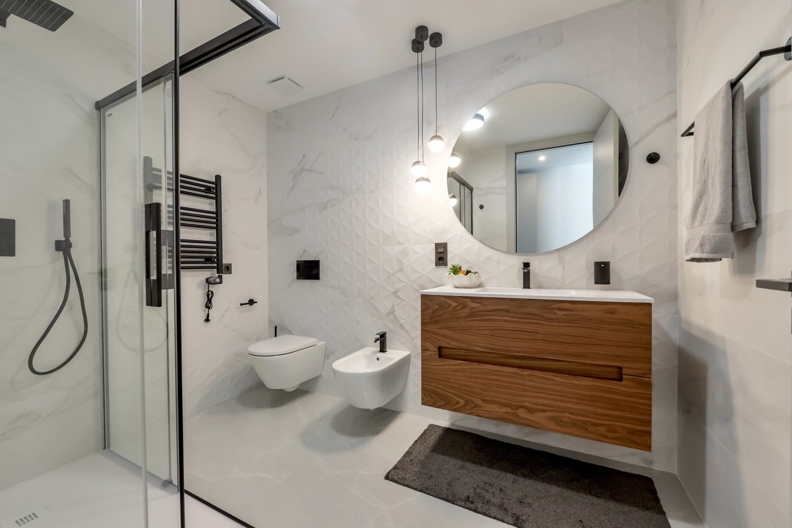 A modern bathroom with a walk-in shower and stylish vanity in a 7-bedroom villa in Finestrat - The Estates