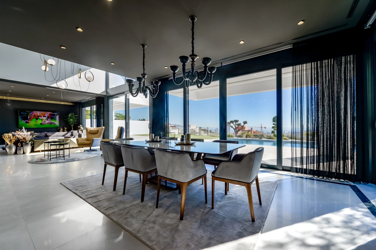 Elegant dining area with stunning sea and city views inside a 7-bedroom villa in Finestrat - The Estates