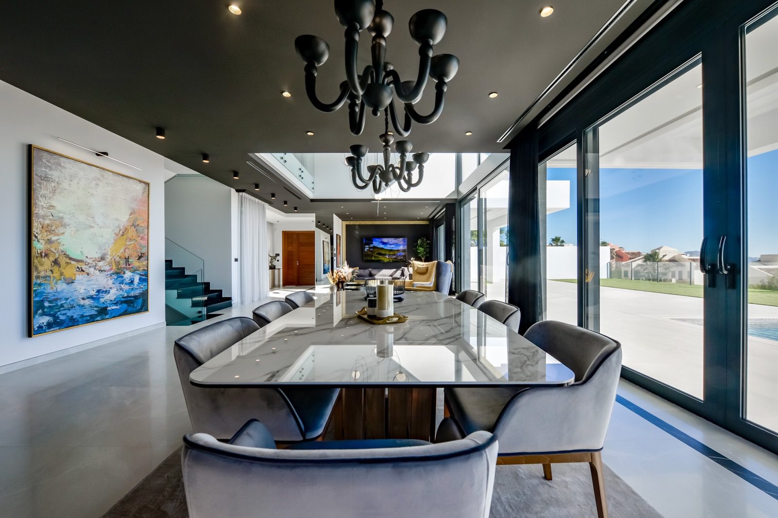 Elegant dining area with stunning sea and city views inside a 7-bedroom villa in Finestrat - The Estates