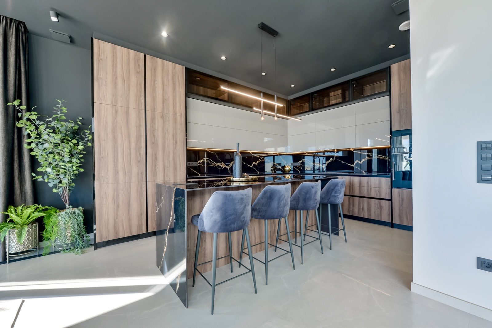 Modern kitchen with bar seating in a 7-bedroom villa in Finestrat - The Estates
