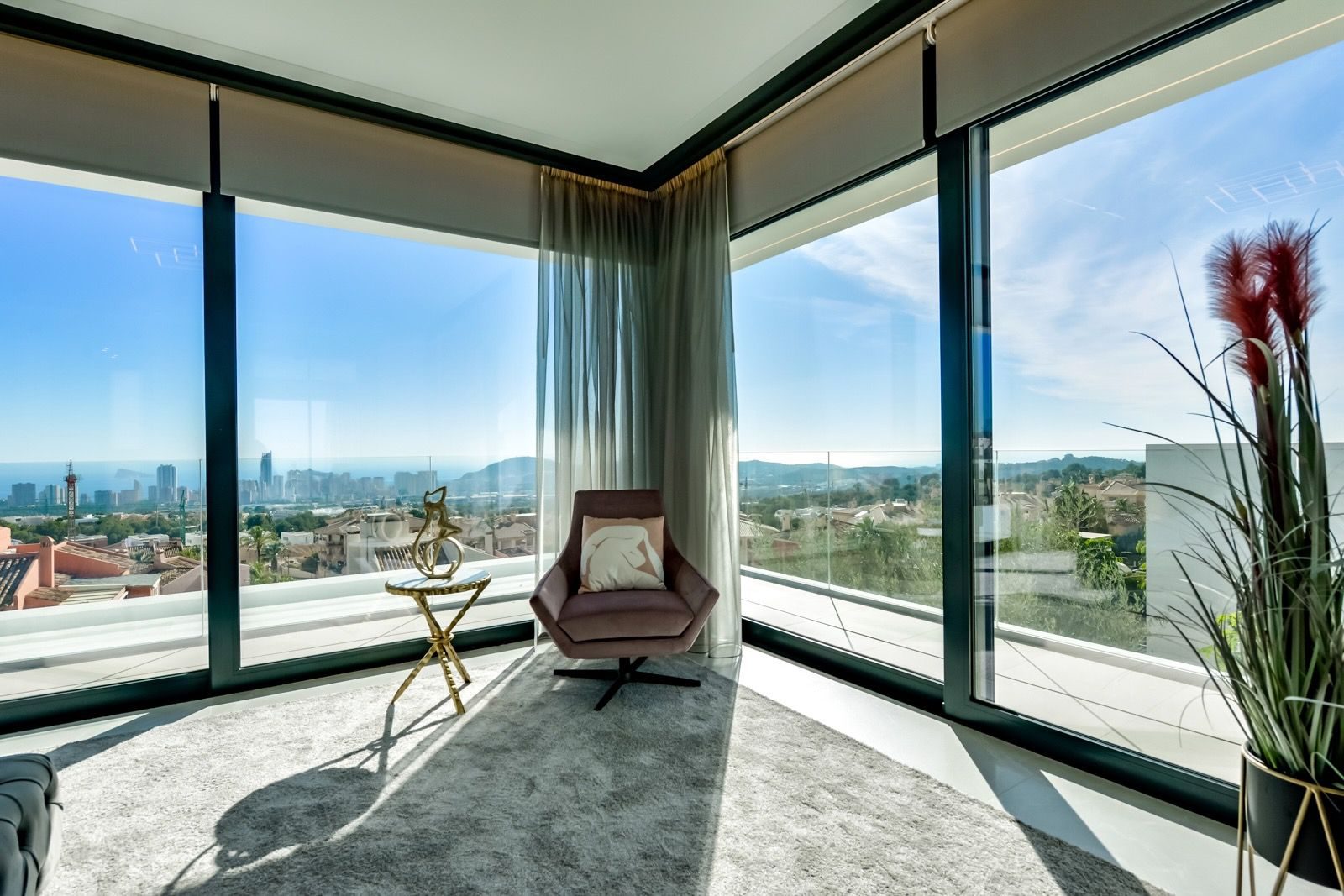 A bright living area with panoramic sea and city views inside a 7-bedroom villa in Finestrat - The Estates