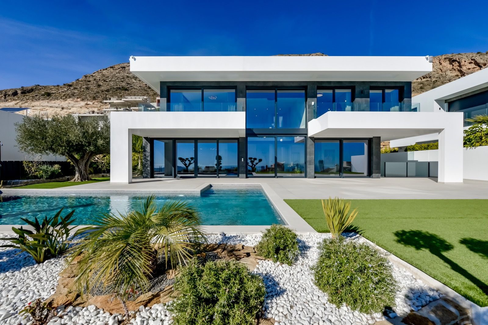 Modern exterior of a 7-bedroom villa with a pool and stunning sea and city views in Finestrat - The Estates