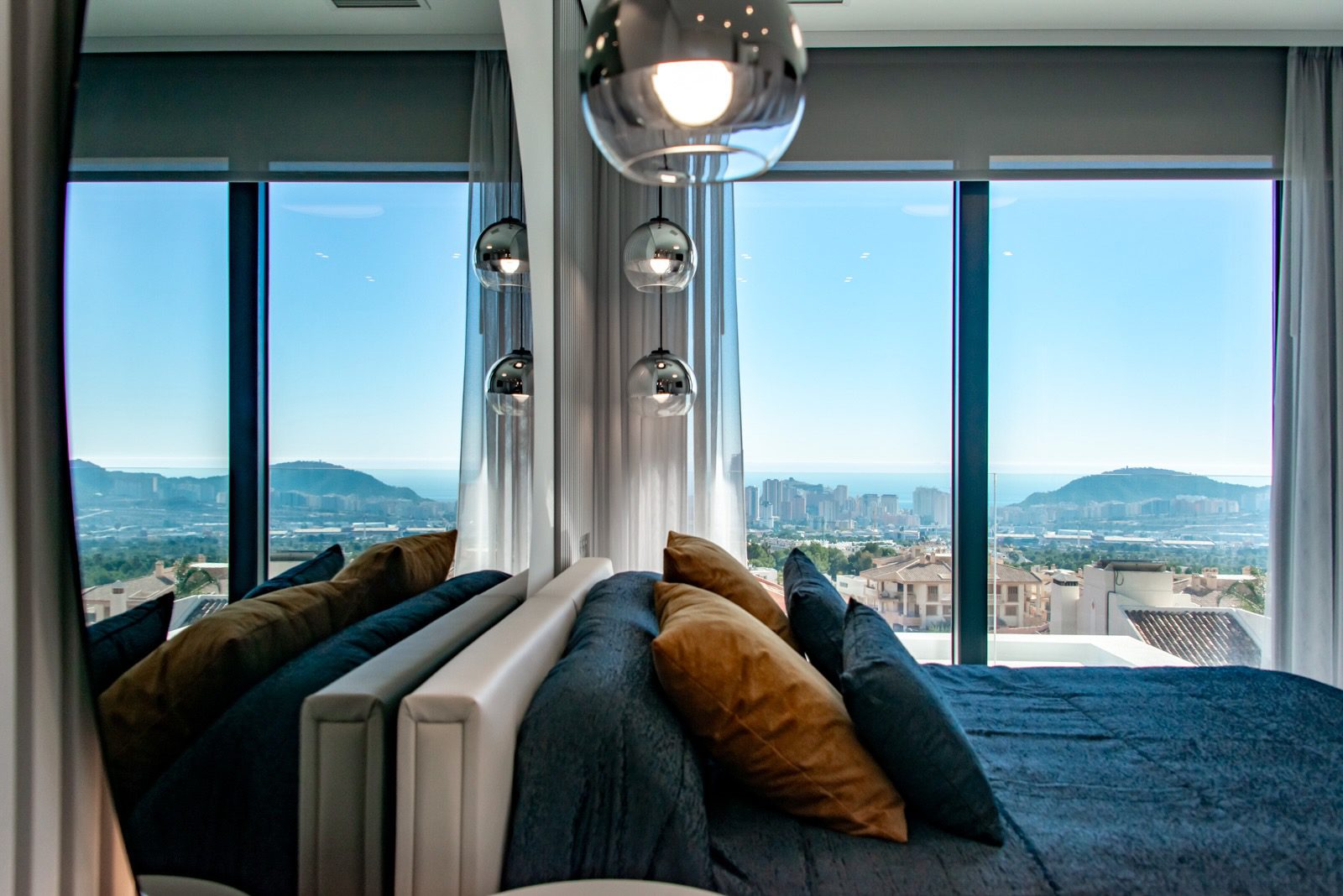 Stylish living room with panoramic sea and city views inside a 7-bedroom villa in Finestrat - The Estates