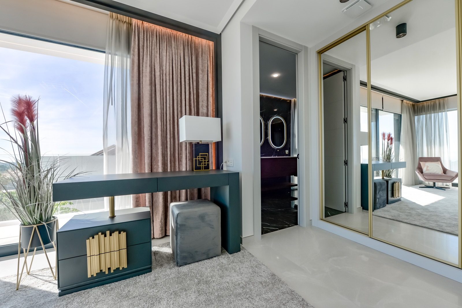 Stylish bedroom with a dressing area and large windows overlooking the sea in a 7-bedroom villa in Finestrat - The Estates